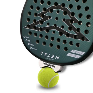 Close-up of a white Padel Pick clip lifting a ball off the court from a padel racket