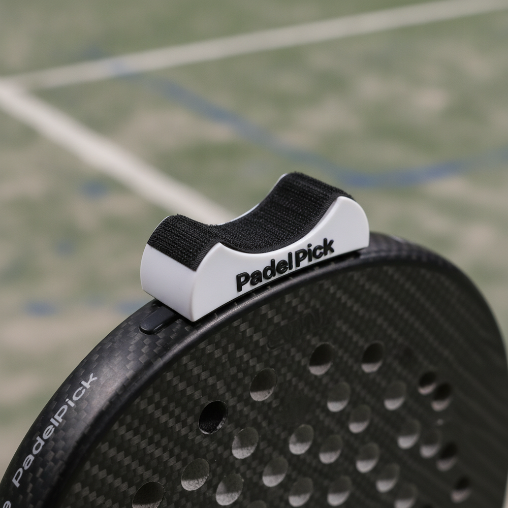 Close-up macro of the white Padel Pick clip on a padel racket frame